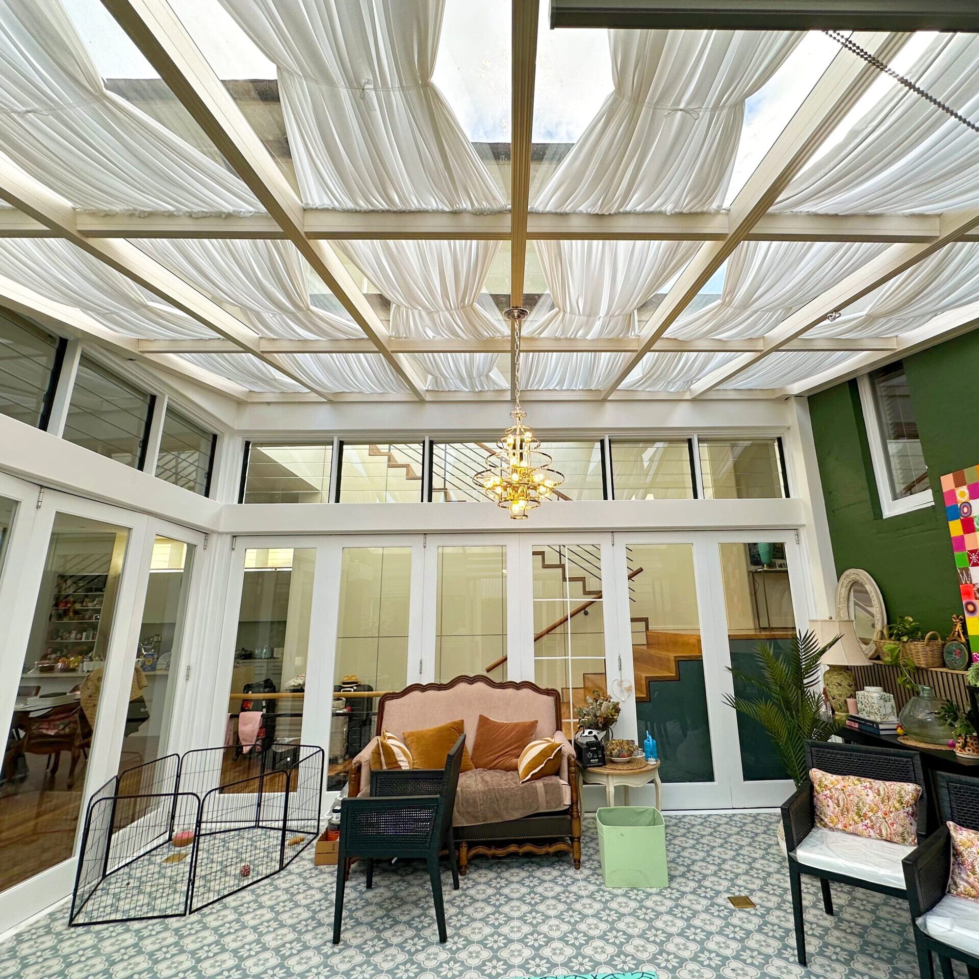 Gordon_sunroom Stylish indoor sunroom in Gordon with glass roof and flowing ceiling curtains