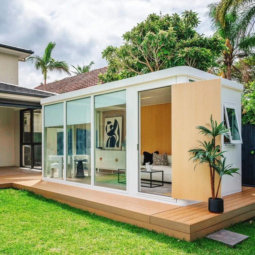 Saint_Ives_Backyard_Home White backyard modular pod with timber deck and glass sliding doors in St Ives